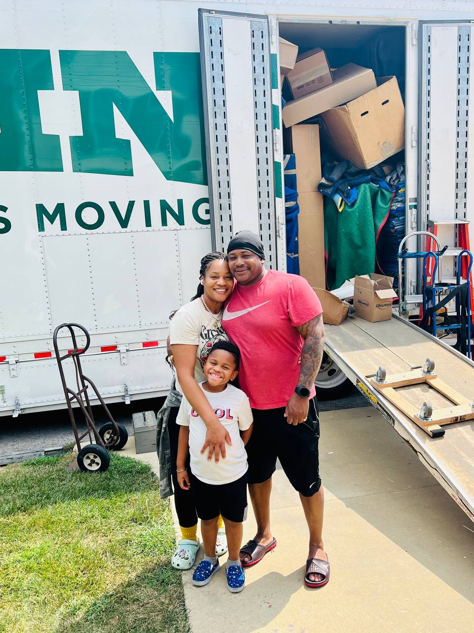 Family on moving day in front of the moving truck