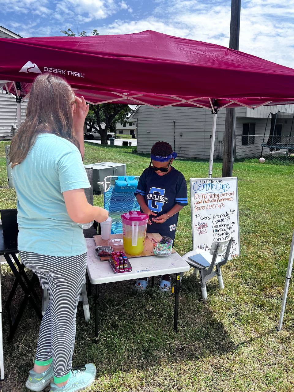 Two kids running a lemonade stand on base